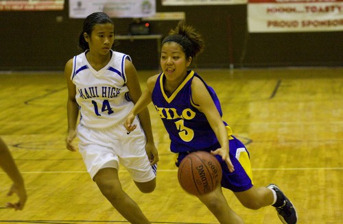 20081205_brittney-unoki Hilo's Brittney Unoki (3) speeds past Maui Saber Ashley Gonzales (14) during high school basketball action at Onizuka Gym for the Konawaena Winter Basketball Classic. Hilo won the game 58-47.