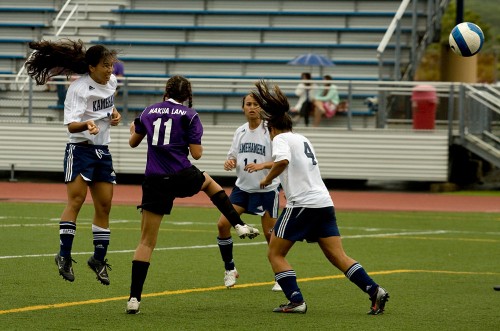 20090103_ksh-score Kamehameha-Hawaii's Pua Hall (15), left, watches her shot sail to the goal for a score in the second half of action against the Makua Lani Lions in Keaau. Kamehameha won the girls match 5-0.