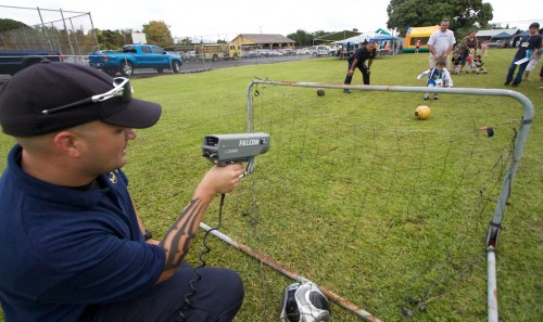 20090110_radar-gun Community Police Officer Jesse Kerr, left, uses a radar gun to check the speed of soccer kicks during the Family Fun Day at Kurtistown Park. The event featured arts, crafts, games, food, sports, entertainment and prizes.