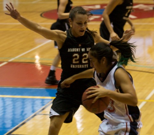 20090128_eileen-pineda-2 UH-Hilo's Eileen Pineda (23), right, drives past Academy of the Arts player Ali-Tyson Taufoou (22) at Afook-Chinen Civic Auditorium. UH-Hilo leads at the half 47-28.