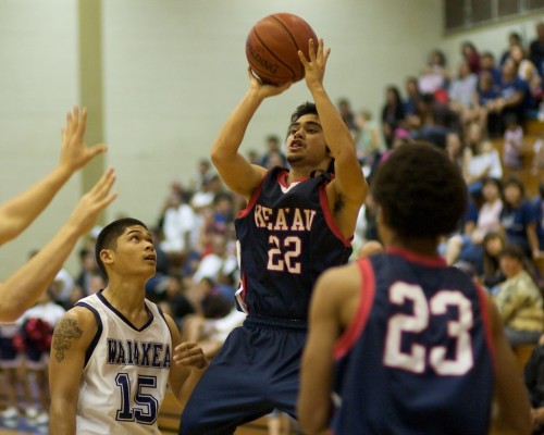 20090128_makana-cazimero Keaau's Makana Cazimero (22) takes a jumper as Waiakea's Matthew Libao (15) and fellow Cougar Jelani Young (23) watch during BIIF basketball action at Waiakea. Keaau leads at the half 30-28.