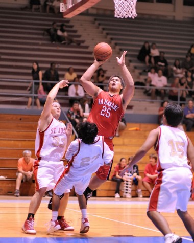 rnm-090130_0004 HPA's Keoki Phillips charges to the hoop over St. Joseph's Royden Masulit.