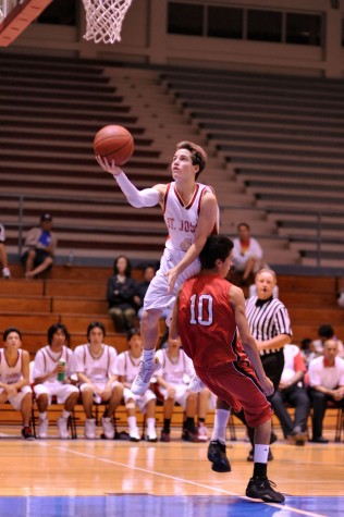 rnm-090130_0005 Jacob Andrade of St. Joseph soars to the hoop over Nathan Schenk.