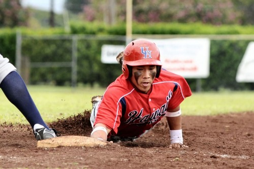 rnm-090214_0003 Hilo's Ronel Trias dives safely back into first base. The speedy leadoff hitter went 1 for two scoring two runs.