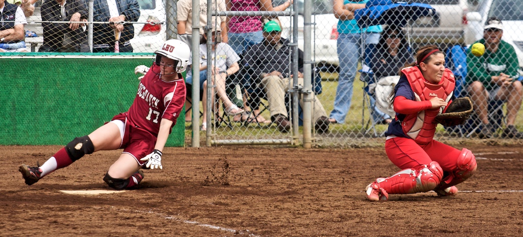 Lock Haven's Nancy O'Connor scores as UH-Hilo catcher Jessica Schatz can't make the play at home during the first game of a doubleheader in Hilo. Lock Haven took the first game 2-1 and lost the second to the Vulcans 1-0. Photos by Baron Sekiya/Hawaii247.com