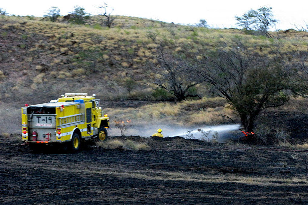 Firefighters knock down fire along ravine near Waikoloa Elementary School and Waikoloa Baptist Church; will monitor hot spots overnight.