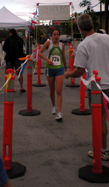 hopsrunhouk Kristi Houk is the first woman across the finish line at 'Run for the Hops' Kona Brewers Festival fun run. (Hawaii247.com photos by Karin Stanton)