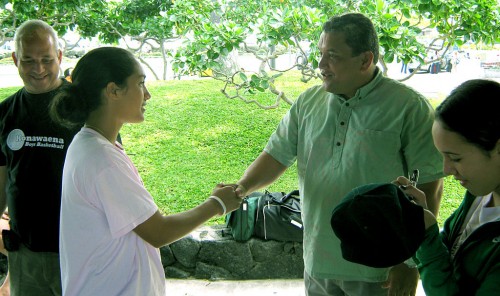 img_0108 Lia Galdeira, most valuable player at the state girls basketball tournament, is congratulated Sunday by Mayor Billy Kenoi, who greeted the Konawaena Wildcats at the Kona International Airport when the team came home following its thrilling 54-50 double-overtime victory Friday over Punahou. Assistant coach Donald Awa (left) looks on, while Kona player Makayla Awa, (right) signs a hat for the mayor.