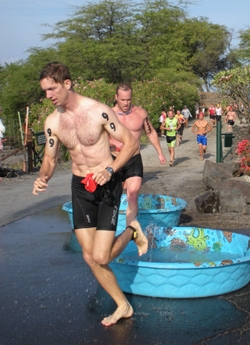 lavamanfeetdip Athletes rinse off their feet while making the transition between the swim and the bike leg at the Waikoloa Lavaman Triathlon. (Hawaii247.com photo by Karin Stanton)