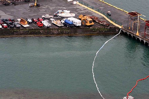 20090409_oil-spill-hilo-harbor U.S. Coast Guard investigators from Marine Safety Detachment, Hawaii, on the Big Island, responded Thursday and Friday to a small oil spill in Hilo Harbor. This photo was taken Thursday, April 9, 2009, by the crew of an HH-65 Dolphin rescue helicopter.