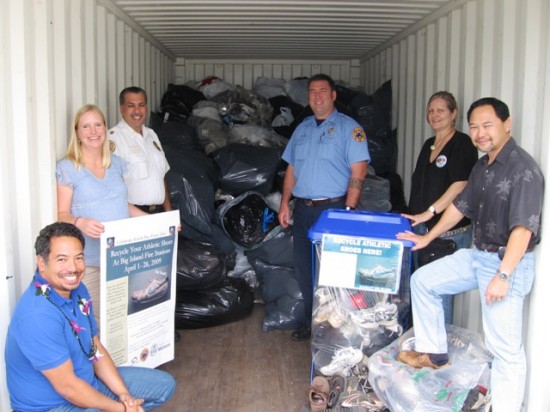 reuseashoe From left, Lono Tyson, Director, Environmental Management, Rebekah Sluss, Environmental Management, Darryl Oliveira, Fire Chief, Rob Wall, Fire Department, Linda Peters, Environmental Management, and Ivan Torigoe, Deputy Director, Environmental Management, help load a container with recycled shoes.