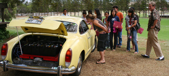 Waimea resident Doug Teeple (right), who has not been to a gas station in more than two years, shares his e-Ghia with students.