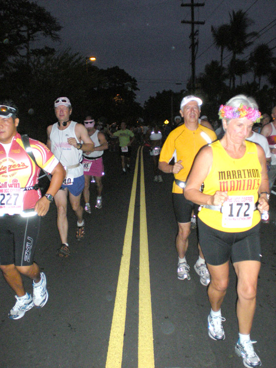 konamarathon2009 Marathon runners take off along Alii Drive at the start of the Kona Marathon. And, yup, it was still dark at 5:30 a.m. (Hawaii247.com photo by Karin Stanton)