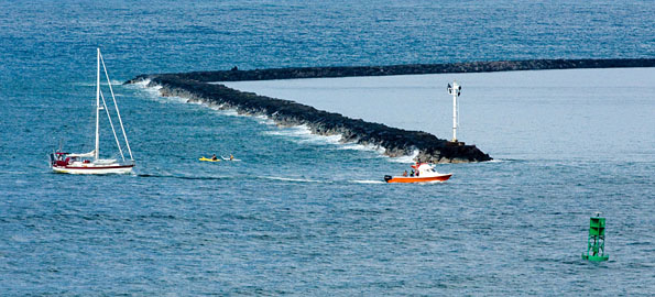 A Fire Department rescue boat tows a disabled vessel into Hilo Bay Tuesday afternoon, July 7.