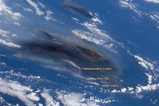 VolcanoWatch080609 This image from the Space Shuttle Atlantis shows distinct gas plumes rising from Kilauea Volcano in Halemaumau Crater and at Puu Oo, the two vents responsible for the vog that shrouds Hawaii Island. An ocean entry plume, created by molten lava from Kilauea’s east rift zone flowing into the sea, is also visible.