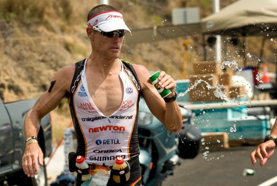 20091010_ironman-run-CraigAlexander Craig Alexander goes for hydration on the marathon course of the Ironman Triathlon. Heat and humidity are taking their toll on runners. Photography by Baron Sekiya for Hawaii 24/7.