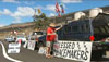 Protesters of the Army's Stryker vehicles and live-fire training at Pohakuloa Training Area gathered near the entrance to the base on Saddle Road. Supporters of the military also had signs and flags at the entrance to counter the protesters.