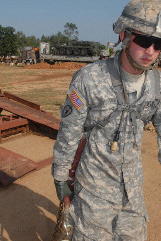 StrykerIndiaVert Spc. Paul West, a mortarman assigned to Troop B, 2nd Squadron, 14th Cavalry Regiment "Strykehorse," 2nd Stryker Brigade Combat Team, 25th Infantry Division, from Schofield Barracks, Hawaii, removes chains while unloading vehicles in preparation for Exercise Yudh Abhyas 09 in Babina, India. (Hawaii247 photo special by Staff Sgt. Cristina Yazzie)