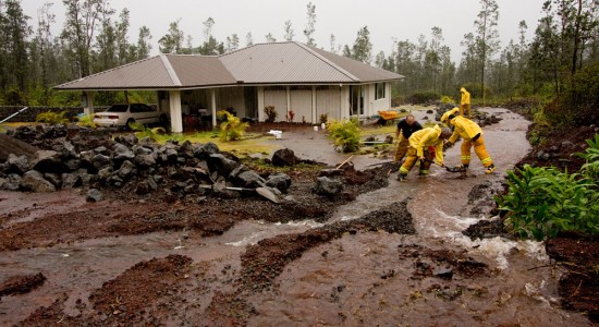 20091219_ainaloa-flooding Firefighters build an embankment to divert floodwaters away from a home in Ainaloa subdivision on Pukalani Street. Photography by Baron Sekiya | Hawaii 24/7.