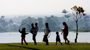 Visitors to Wailoa River State Park walk along the shore as vog blankets Hilo in the background. Kona winds pushed the vog from Kilauea Eastward. Hawaii 24/7 File Photo