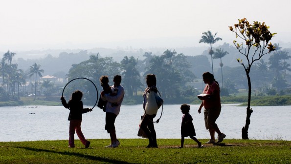 Visitors to Wailoa River State Park walk along the shore as vog blankets Hilo in the background. Kona winds pushed the vog from Kilauea Eastward. Hawaii 24/7 File Photo