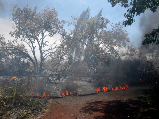 lavaflow The air was thick with smoke from burning vegetation and asphalt late Saturday. Flows here were crossing Highway 137 and moving slowly toward the residence, which burst into flames about 3:30 a.m. Sunday. (Photo courtesy of Hawaiian Volcano Observatory)