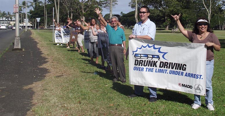 The Hawai'i  Police Department's Traffic Services Section organized a sign-waving event on Kamehameha Avenue in Hilo on Thursday (August 19) to make motorists aware of the "Over The Limit – Under Arrest" National Crackdown from August 20 to September 6.