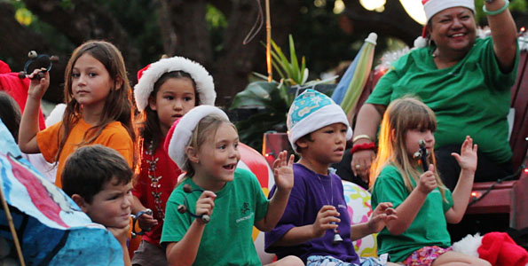 Village turns out to cheer floats, bands, dancers, local volunteer groups, keiki clubs and a lot of dogs