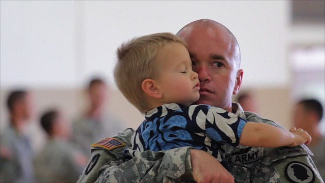 CW2 Peter Bianchi gives his two year-old son Cooper a hug before deployment ceremonies for the Hilo based Hawaii Army National Guard aviation unit. Bianchi's wife Kiara also joined other family members and friends seeing off the troops.