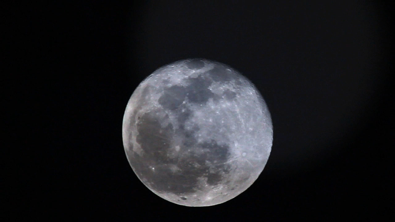 Just the moon through the clouds over Puna.