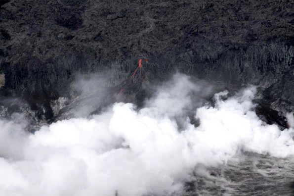 20111227_west-kailiili-lava-stream One of the individual streams of lava cascading over the sea cliff, producing a thick steam plume at the waterâs edge. Photo courtesy of USGS/HVO