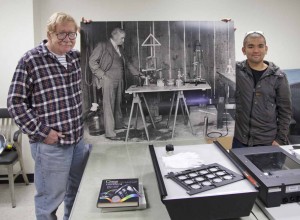 Ben_Gaddis-Andrew_Hara-Jagger-photo Volunteers Ben Gaddis (left) and Andrew Hara (right) holding a photo of Thomas Jaggar in his gas lab in 1916. Photo courtesy of USGS/HVO