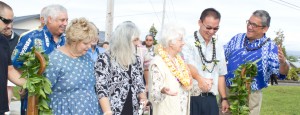 MachadoAcresPark Mayor Billy Kenoi (far right) and Councilman J Yoshimoto welcome the Machado family and neighbors from the Machado Acres community into their new park. Photo courtesy of the Hawaii County Mayor's office.