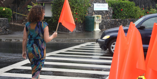 Pedestrians are encouraged to take a PedFlag, cross the street, and replace the flag in the holder on the opposite side for the next pedestrianâ€™s use