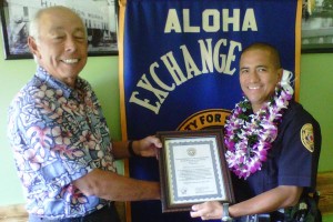 OfficerOfTheMonth-March-Nacis Hilo Exchange Club Board Member Joey Estrella presents an "Officer of the Month" for March plaque to Officer Keith Nacis.
