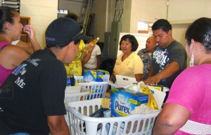20120428_HiloZonta-Baskets Zontian Debbie Shigehara orchestrates creating "Move in Packs" with HOPE volunteers. The packs will help formerly homeless folks get started in new homes.