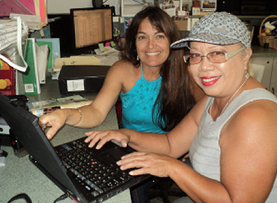 Cindy Naihe reviews computer course with partner family member Aloha Kekauoha. (Photo courtesy of Habitat for Humanity)