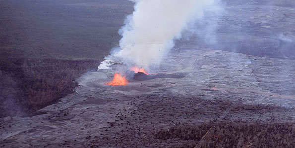 A lava fountain during the opening episode of the Mauna Ulu eruption feeds lava flows that cover Chain of Craters Road. Both ‘Alo‘i Crater (lower left) and ‘Alae Crater (upper right) were filled with lava later in the eruption. Photo taken on May 28, 1969. Photo courtesy of USGS/HVO