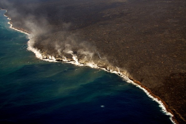 Activity at the ocean entry near Kupapaʻu Point has increased slightly over the past several days, with small entry points now spread along the coastline on both sides of the National Park boundary. Whale watching season has also arrived—the splash of whitewater near the bottom center part of the photo is from a breaching whale investigating the ocean entry. Photo courtesy of USGS/HVO