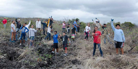 Kealakehe Intermediate Na Kahumoku students after pulling fountain grass at Lai Opua Preserve. This activity was followed up with an hour of reinforcing e-curriculum at the Lai Opua 2020 Mālie Tech Center. (Photo courtesy of Yvonne Yarber Carter)