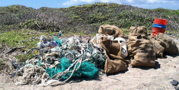 The 209.6 lbs of “marine debris” loot (e.g., fishing nets, miscellaneous plastic debris and a bucketful of microplastics) during less than an hour of scouring by HWF and volunteers at Kamilo. (Photo courtesy of Harold Leatherman | HWF volunteer)
