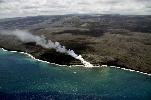Two ocean entry points remain active near Kupapaʻu Point, near the boundary of Hawaiʻi Volcanoes National Park. The eastern entry has produced a larger plume than that at the western entry, which tends to be weak and wispy. On Tuesday (June 11) several small breakouts were active just inland of the eastern entry point, creating a narrow cascade of lava pouring down the sea cliff. Photo courtesy of USGS/HVO