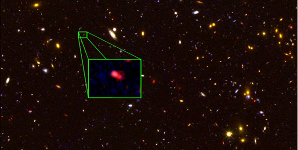 This image from the Hubble Space Telescope CANDELS survey highlights the most distant galaxy in the universe with a measured distance, dubbed z8_GND_5296. The galaxy's red color alerted astronomers that it was likely extremely far away, and thus seen at an early time after the Big Bang. (Image courtesy of V. Tilvi, S.L. Finkelstein, C. Papovich, A. Koekemoer, CANDELS and STSCI/NASA)