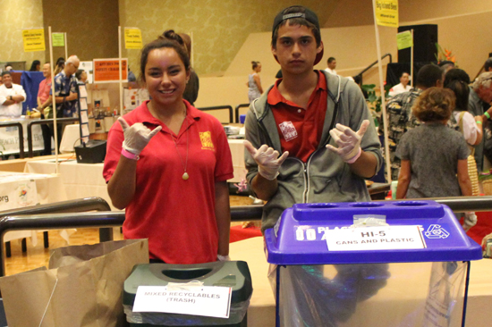 Kanu O Ka Aina Public Charter School students man the recycle bins. (Hawaii 24/7 photo by Karin Stanton)