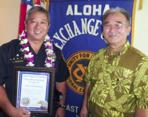 Aloha Exchange Club president Jay Kimura presents an 'Officer of the Month' plaque to Lloyd Ishikawa.