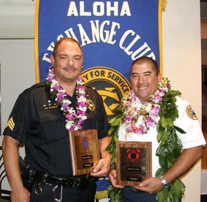 Sergeant James Correa, at left, and Captain Darwin Okinaka display plaques from the Aloha Exchange Club of East Hawaiʻi honoring them as 'Officer of the Year' and 'Firefighter of the Year.'