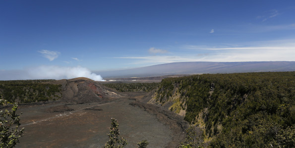One of the most popular vantage points and hiking trails in Hawai‘i Volcanoes National Park: Kīlauea Iki crater and trail, with Halema‘uma‘u plume,and Mauna Loa, both seen in the distance. NPS Photo/Michael Szoenyi