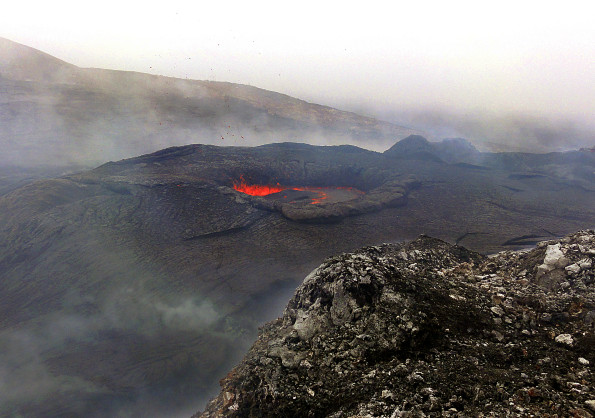 A closer view of the lava pond in the northeast portion of Puʻu ʻŌʻō crater Monday (April 7, 2014). The lava pond has partially closed over the past several weeks, and today was about 5 meters (yards) in diameter - about half of the diameter from two weeks ago. The pond was spattering, with small bits of airborne spatter visible in this photograph. Photo courtesy of USGS/HVO
