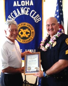 Hilo Exchange Club President Andy Iwashita presents an 'Officer of the Month' award to Detective Robert Almeida.