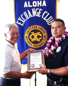 Hilo Exchange Club President Andy Iwashita presents an 'Officer of the Month' award to Officer Eddie Cardines Jr.